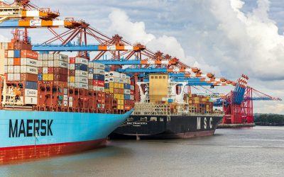 blue and red cargo ship on dock during daytime